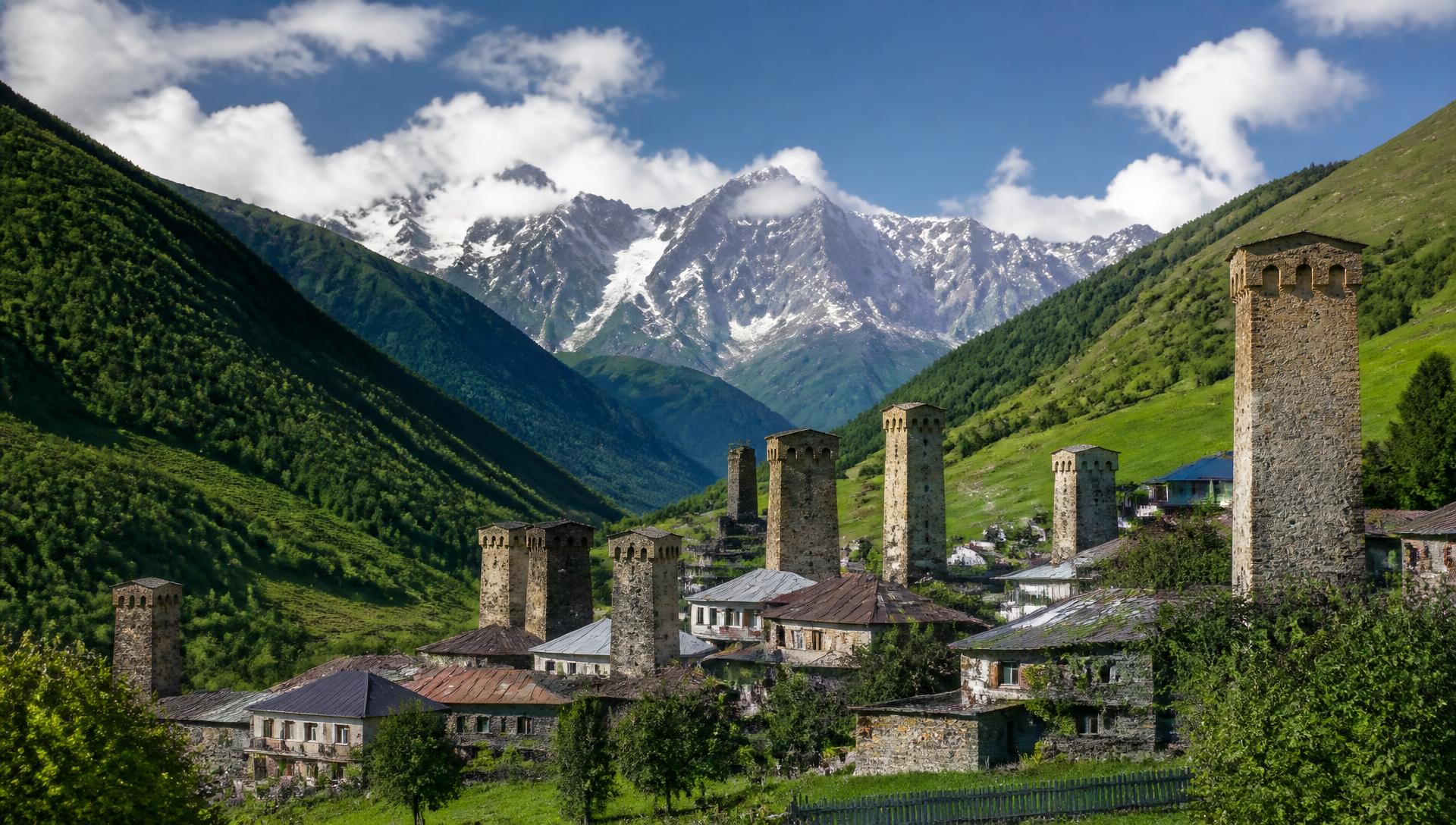 Svan towers and Caucasus mountains in Mestia