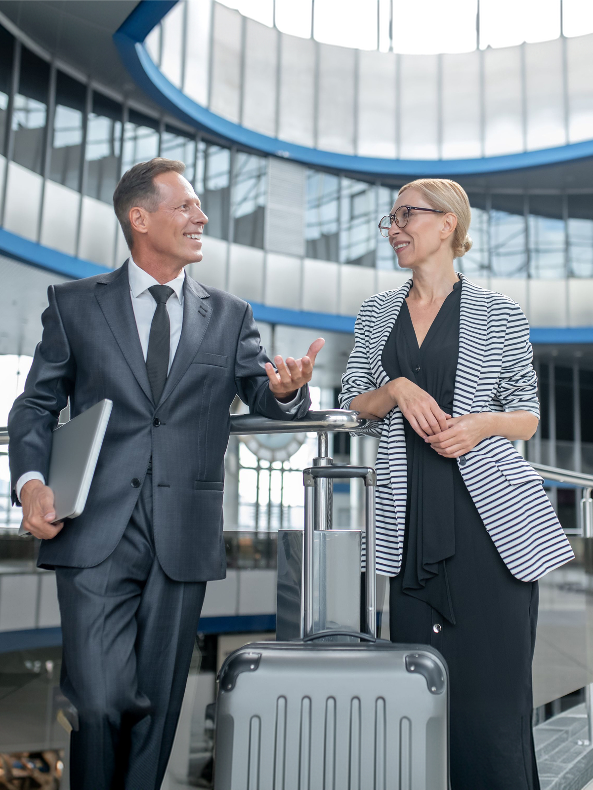 Business travellers arriving with luggage