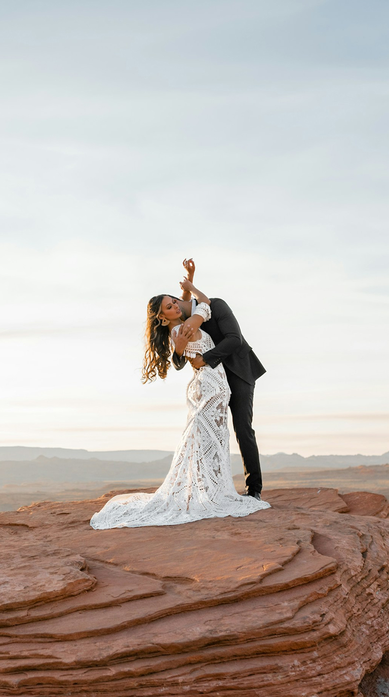 Bride and groom celebrating beside the coast