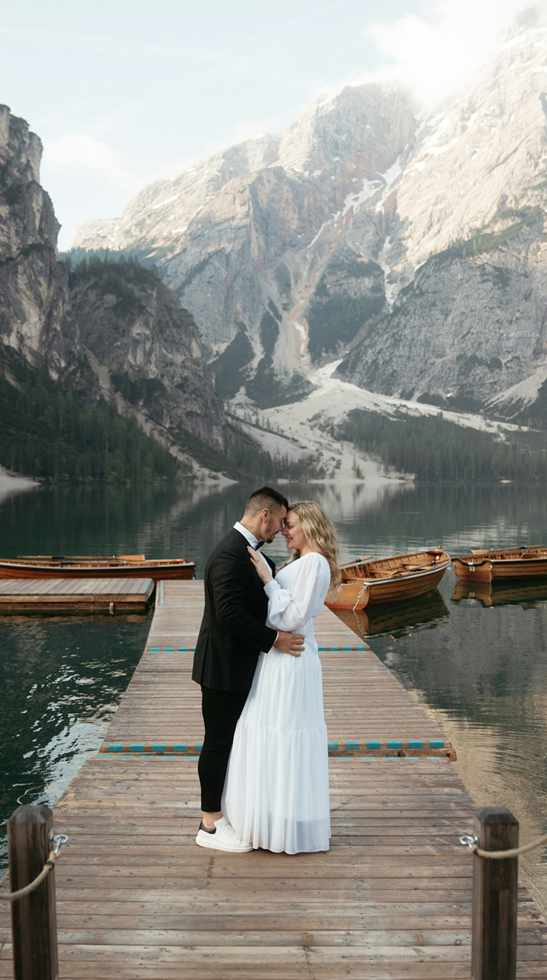 Bride and groom beside a mountain lake