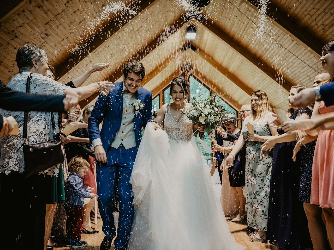 Wedding guests celebrating with the bride and groom