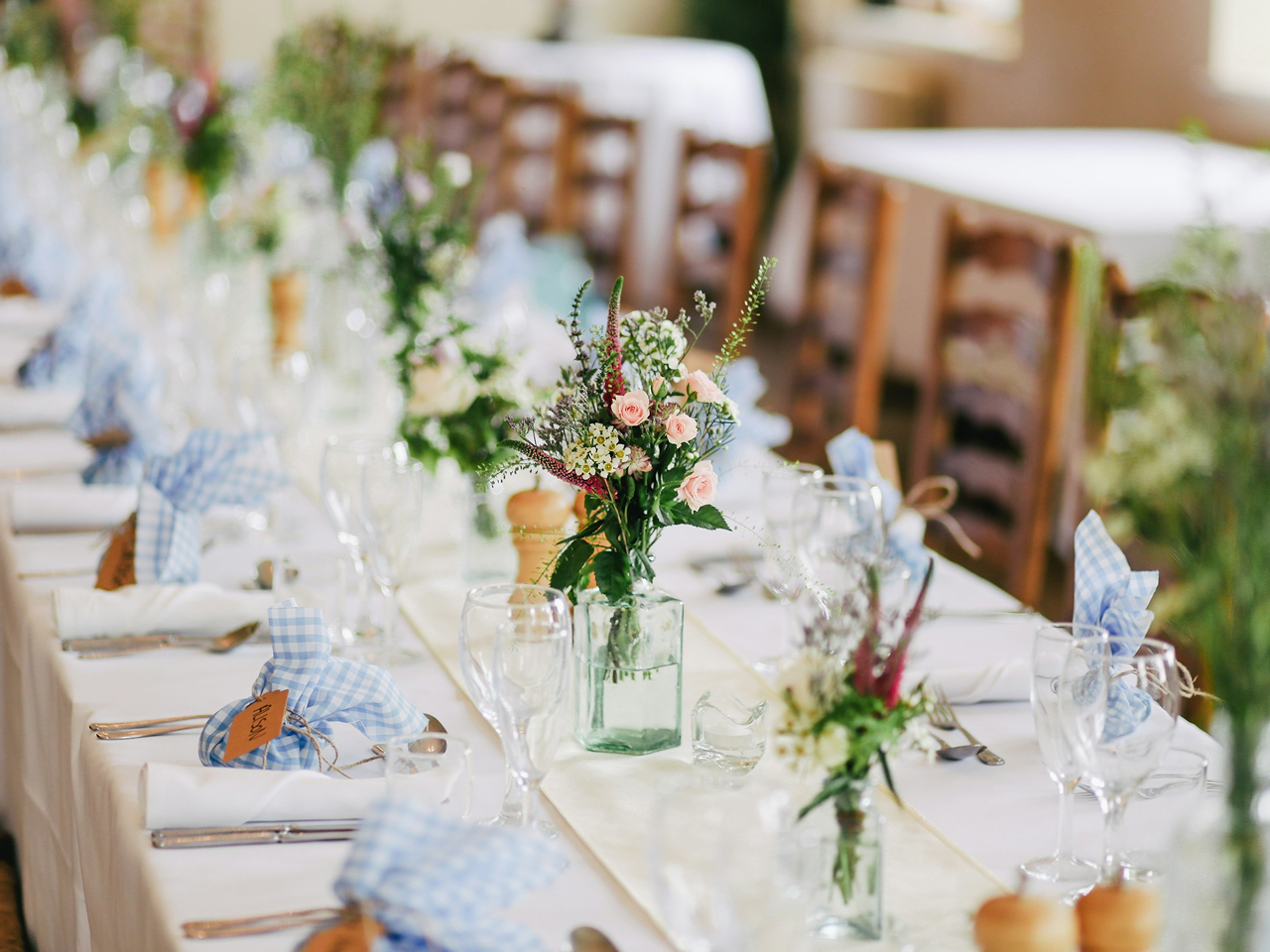 Wedding reception table decorated with flowers and glassware