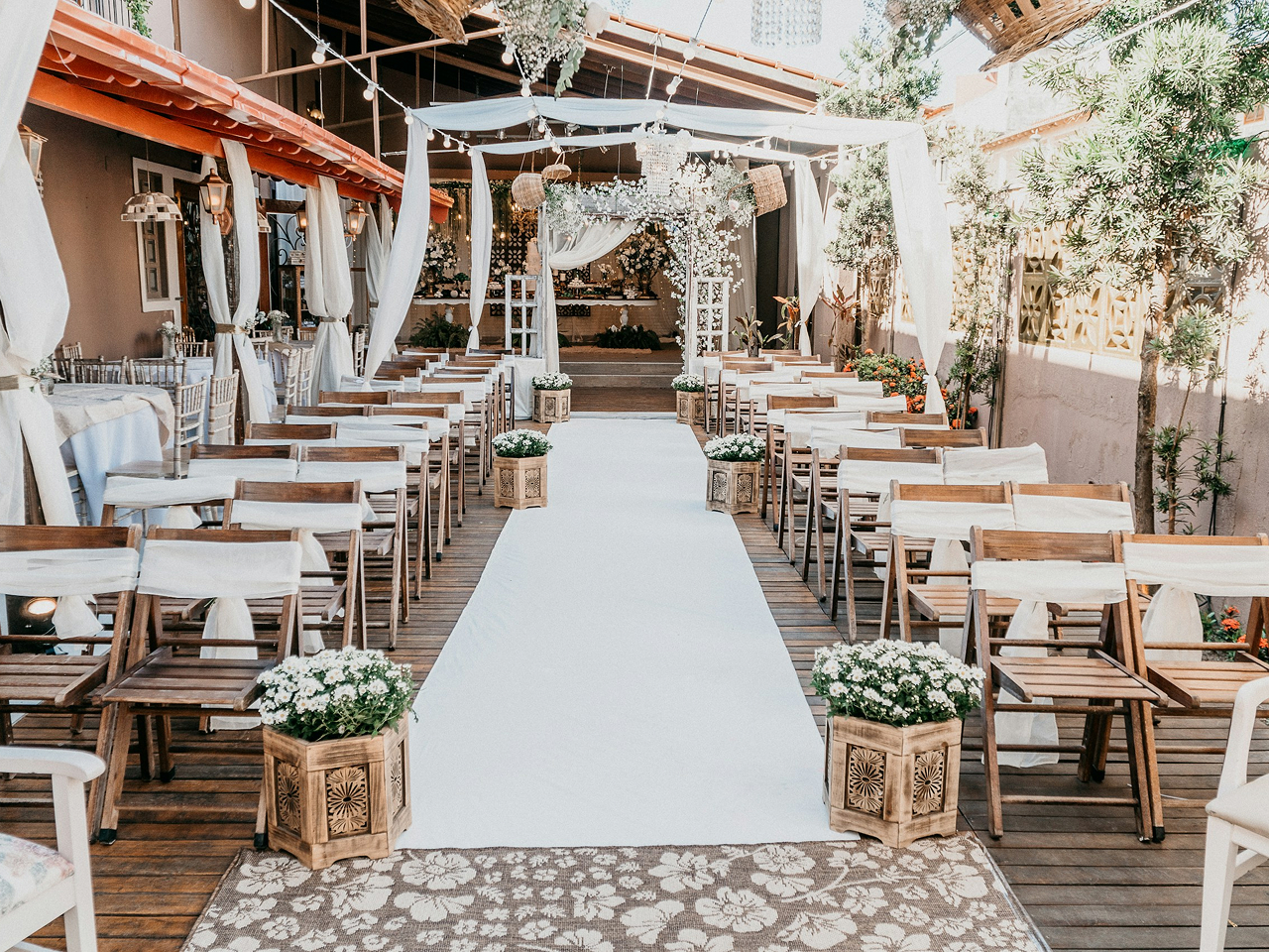 Outdoor wedding venue prepared with chairs and a floral arch