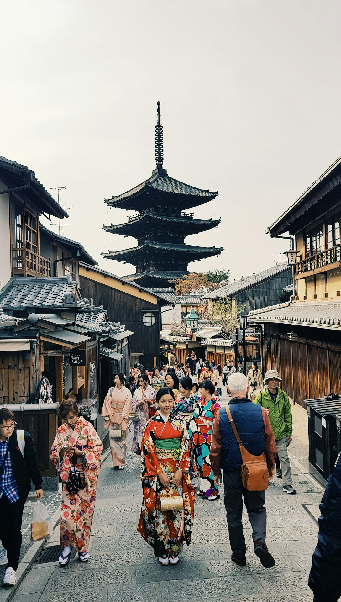 Visitors walking through a historic Japanese temple district