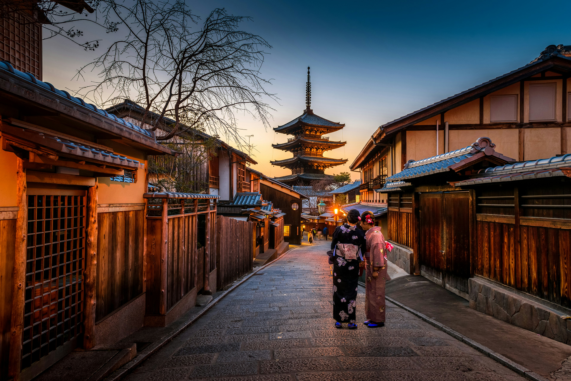 Travellers walking along a historic street in Japan