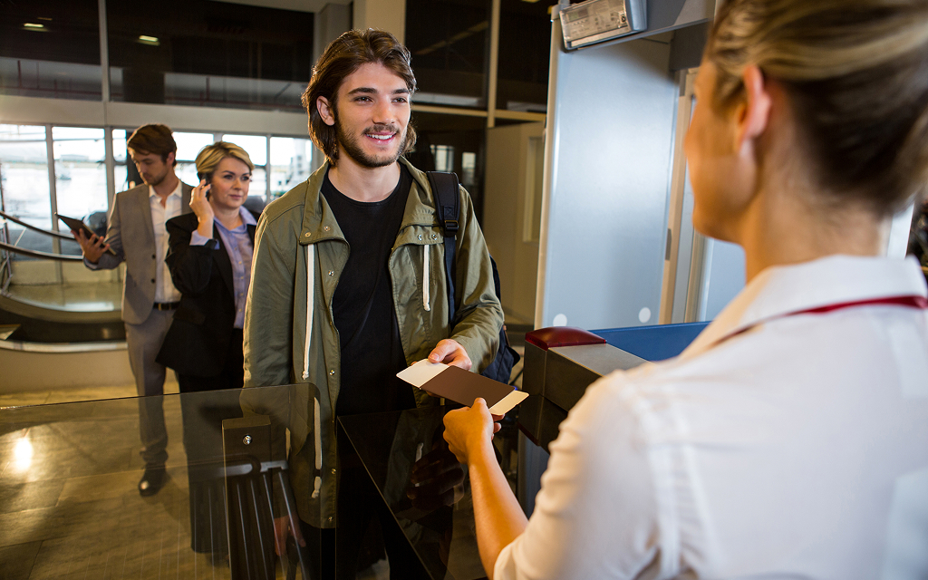 Traveller receiving assistance at an airport check-in desk