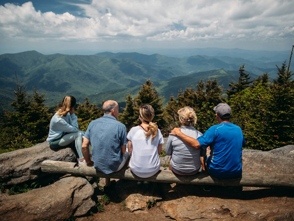 Travellers relaxing together at a mountain viewpoint