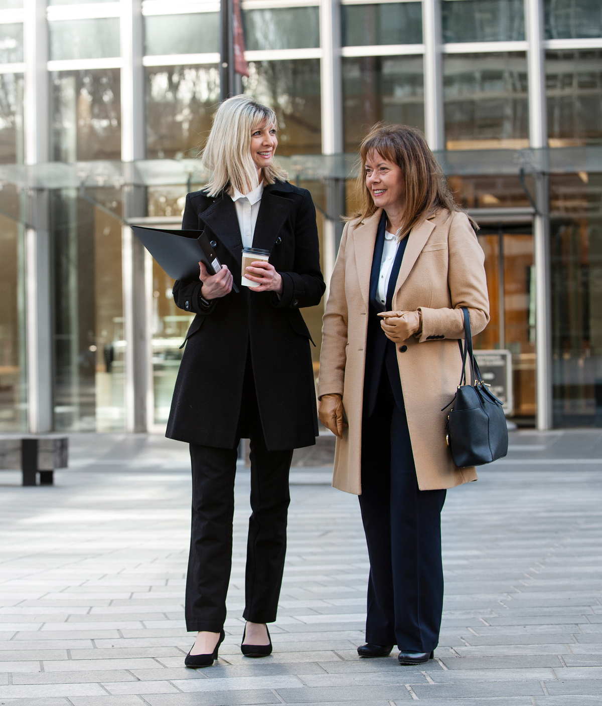 Business travellers walking together with luggage