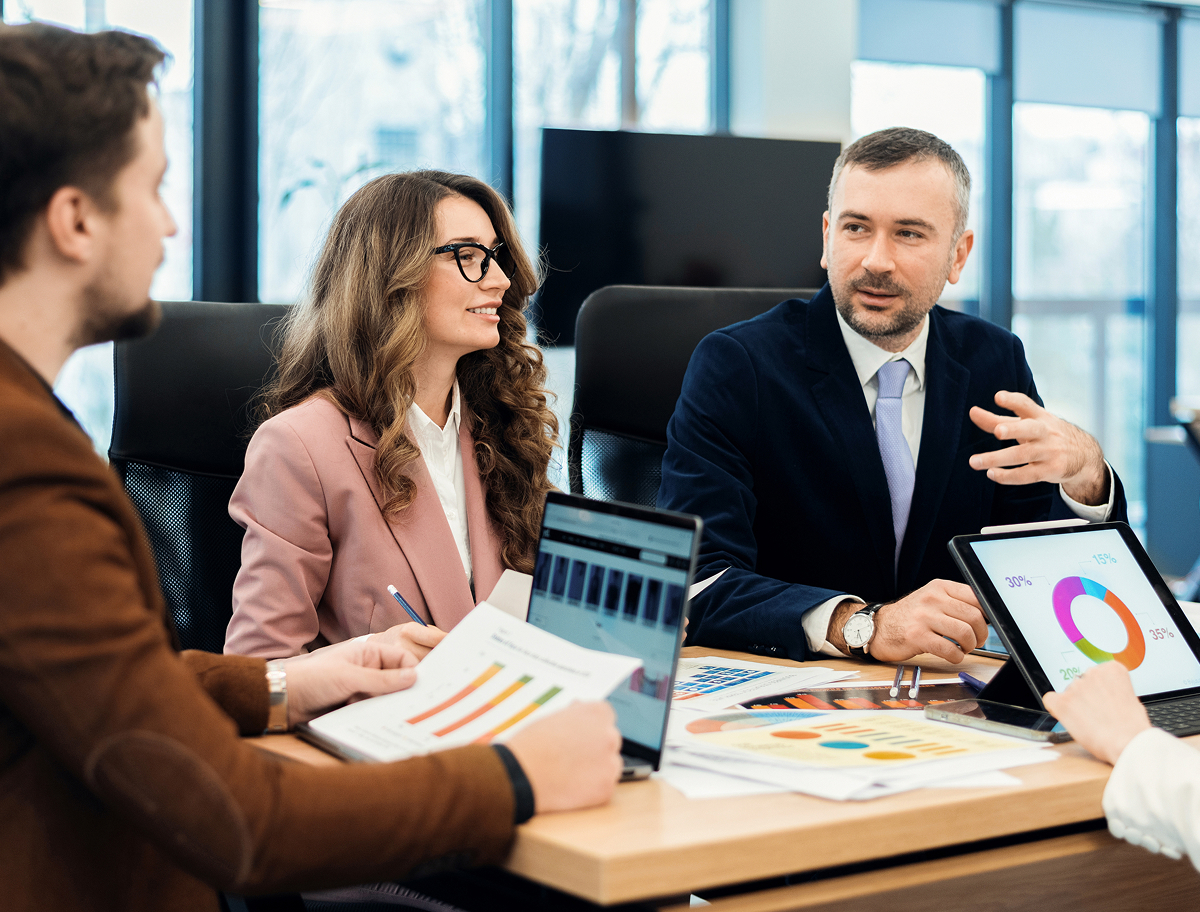 Corporate team meeting with charts and planning materials